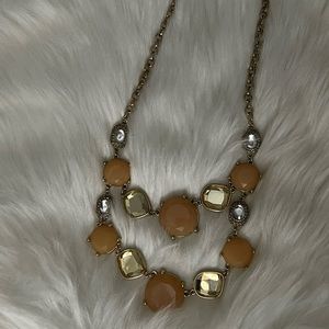 Tiered Gemstone Necklace features gold tone chain and stones